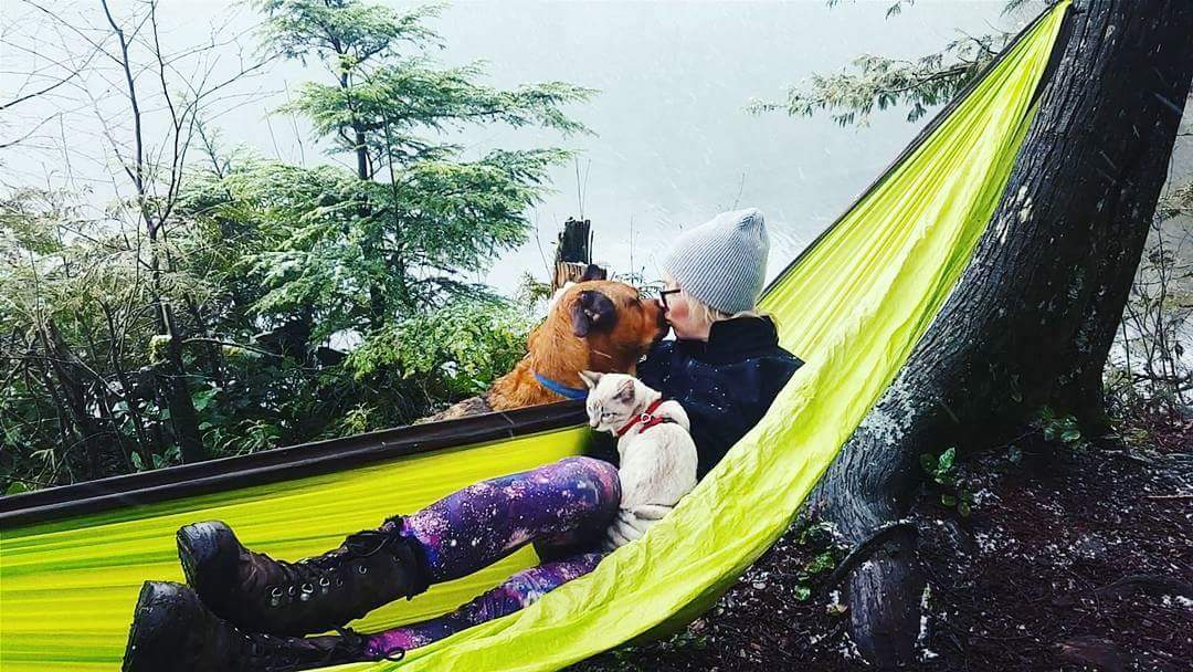 Keshia gives Winston a smooch while snuggling Shasta in a hammock