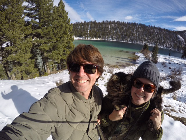 couple hiking with cat in snow