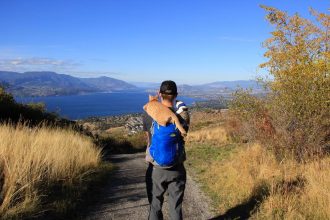 man with two cats riding on his shoulders